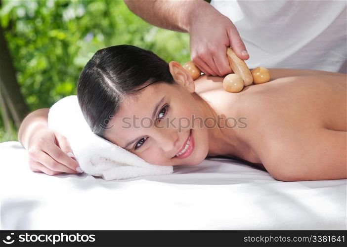 Beautiful young woman getting massage by a therapist