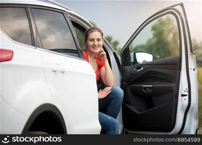 Beautiful young woman got lost while driving car at countryside