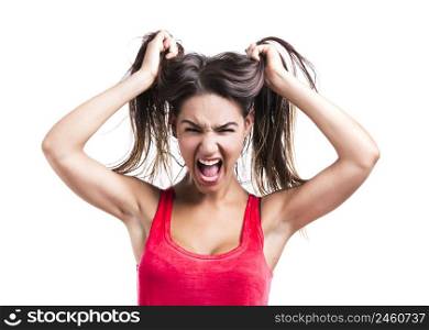 Beautiful young woman grabbing her own hair, isolated over white backgrund