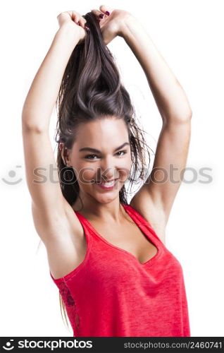 Beautiful young woman grabbing her own hair, isolated over white backgrund