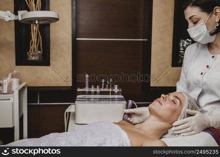 beautiful young woman having cosmetic treatment spa