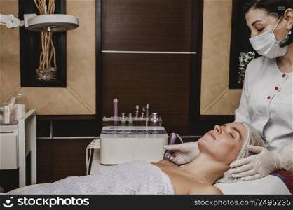 beautiful young woman having cosmetic treatment spa
