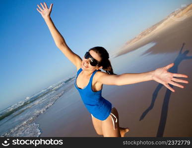 Beautiful young woman having fun on the beach