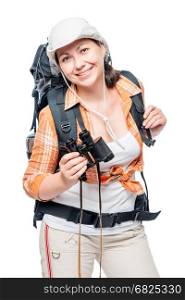 Beautiful young woman hiking with a backpack and binoculars posing