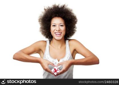 Beautiful young woman holding a gift in front of her heart, isolated on white