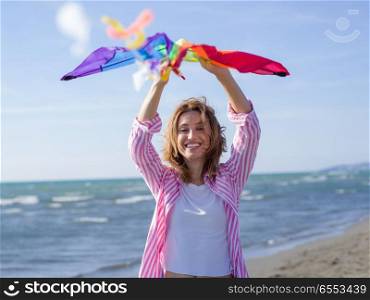 Beautiful Young Woman Holding A Kite at Beach on autumn day. Young Woman holding kite at beach on autumn day