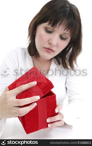 Beautiful young woman holding red gift box.