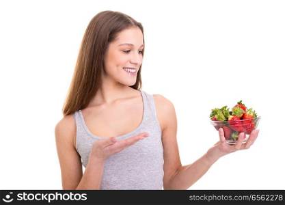 Beautiful young woman holding some strawberries, isolated over white background