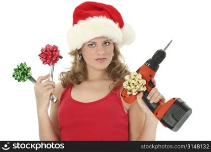 Beautiful young woman holding up tools with bows on them. Wearing santa hat and red tank top. Shot over white.