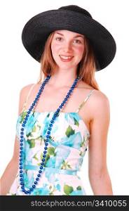 Beautiful young woman in a blue and green dress and pearl chain with an big black straw hat, smiling and looking in the camera, over white.