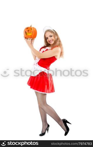 Beautiful young woman in a costume of sexy maid holding halloween pumpkin.