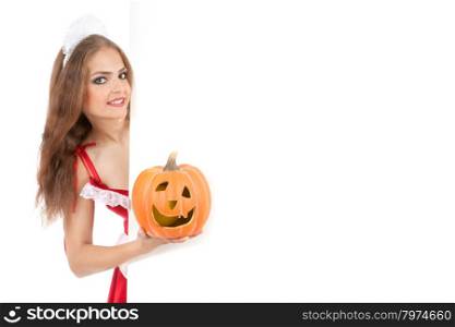 Beautiful young woman in a costume of sexy waitress pointing the sign and holding Jack O&rsquo;Lantern.