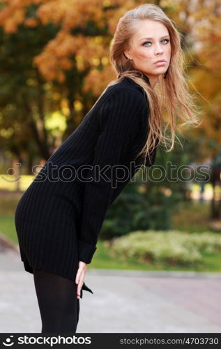 Beautiful young woman in autumn park