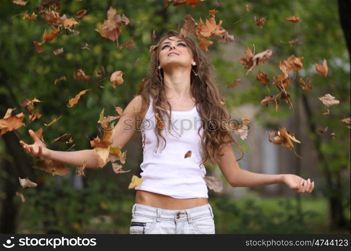 Beautiful young woman in autumn park