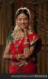 Beautiful young woman in bride attire smiling