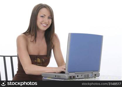 Beautiful young woman in casual clothes working on laptop computer. Fantastic teeth and beautiful complextion. Sitting at tile top bistro table over white background.