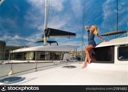 beautiful young woman in casual wear standing on a yacht fore at Trogir marina, Croatia, Europe. beautiful young woman in casual wear standing on a yacht fore at Trogir marina, Croatia