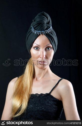 beautiful young woman in east turban on dark background