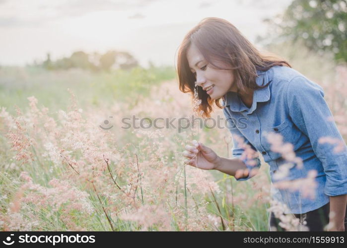 Beautiful young woman in field and enjoy with nature at sunset.