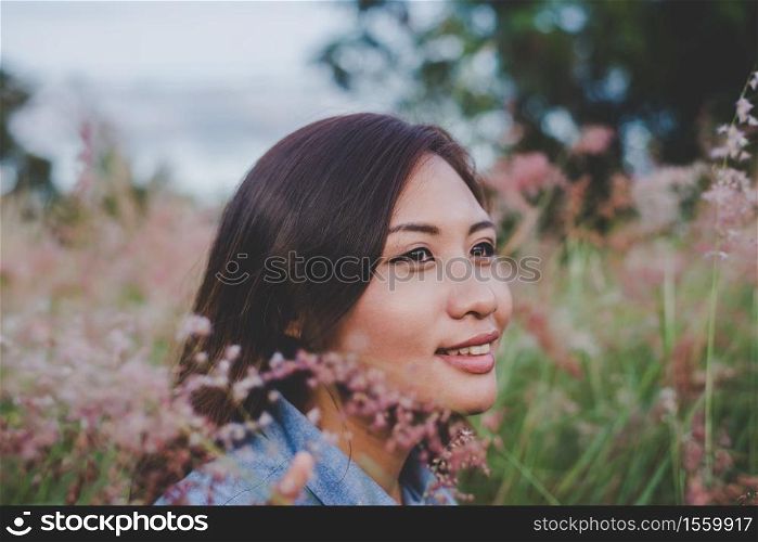 Beautiful young woman in field and enjoy with nature at sunset.