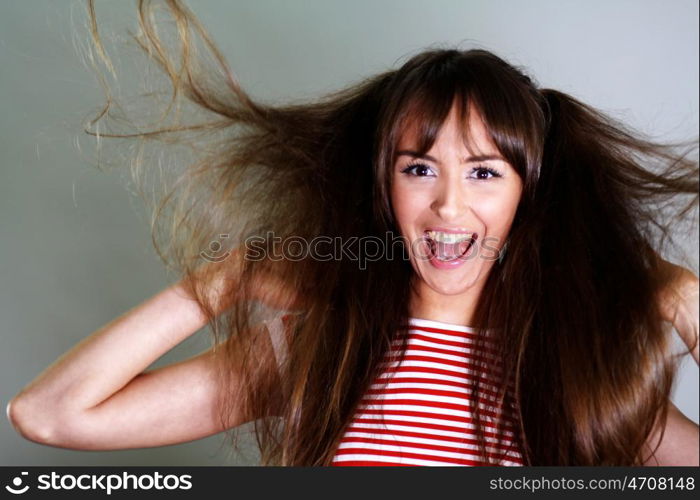 Beautiful young woman in gray background