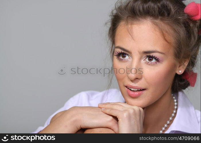 Beautiful young woman in gray background