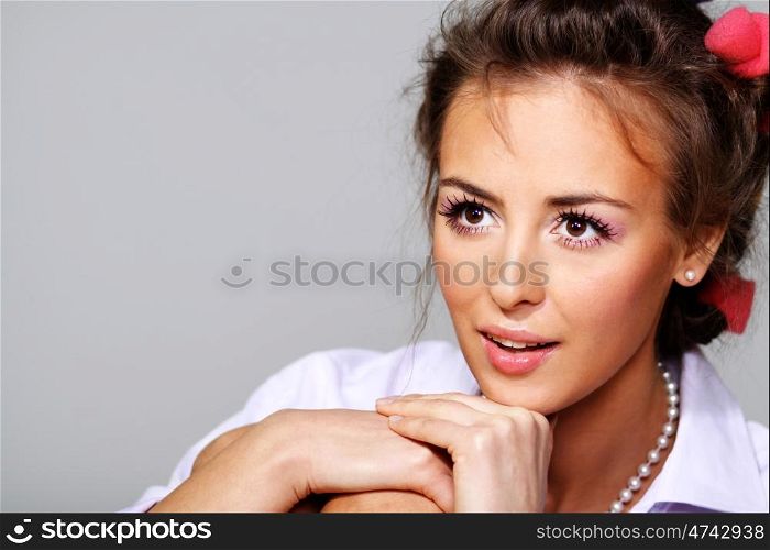 Beautiful young woman in gray background