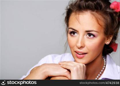 Beautiful young woman in gray background