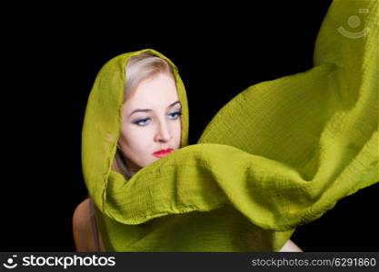 beautiful young woman in green summer shawl isolated on black background