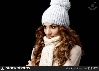 Beautiful young woman in knitted woolen sweater and cap. Beautiful young woman wearing woolen sweater and cap