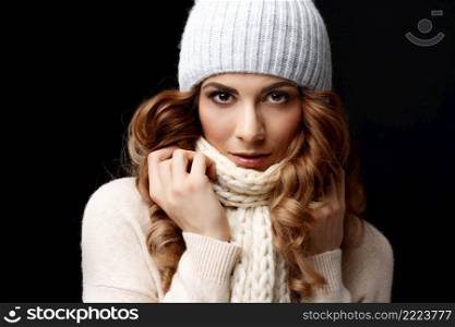 Beautiful young woman in knitted woolen sweater and cap. Beautiful young woman wearing woolen sweater and cap