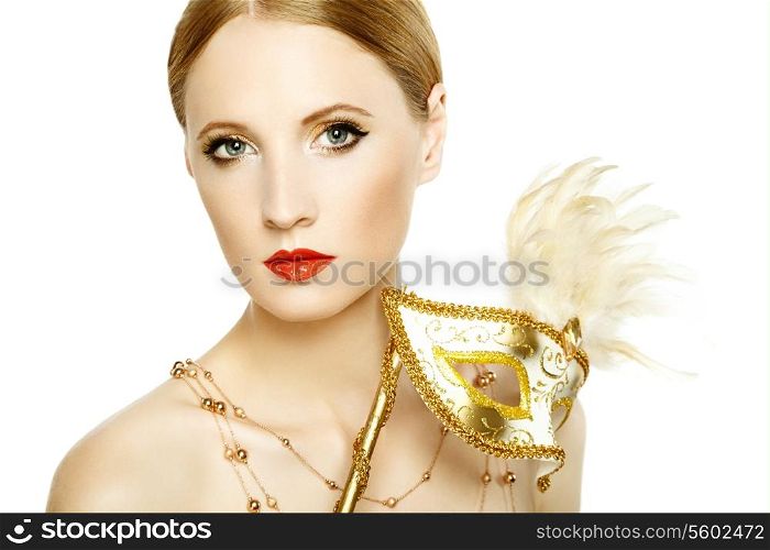 Beautiful young woman in mysterious golden Venetian mask. Fashion photo