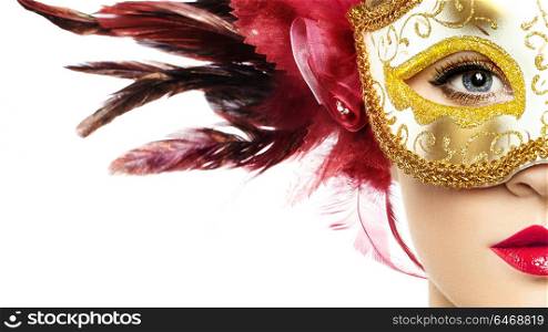 Beautiful young Woman in Mysterious Golden Venetian Mask. Fashion photo. Masquerade Mask with Red Feathers