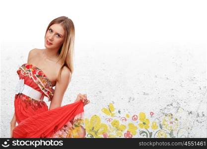 Beautiful young woman in red dress and flowers