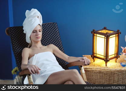 Beautiful young woman in spaand wellness. Face back and stone massage