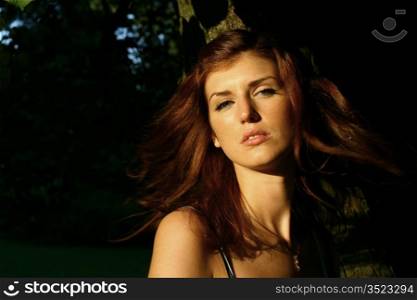 Beautiful young woman in summer forest
