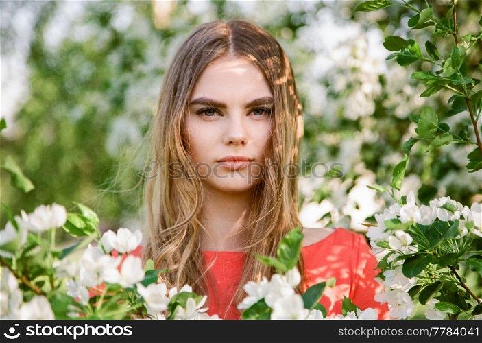 Beautiful young woman in summer garden. Beauty summertime. Film photography