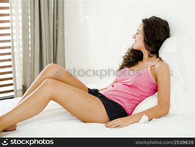 Beautiful young woman in the bedroom after waking up