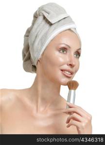 beautiful young woman in towel,with a brush for a makeup