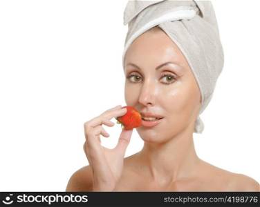 beautiful young woman in towel with a strawberry, isolated on white background