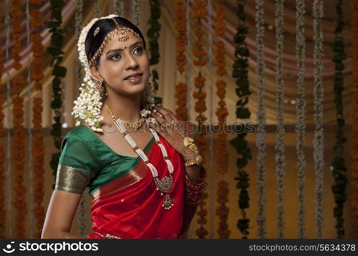 Beautiful young woman in traditional sari looking away