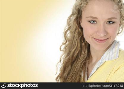 Beautiful young woman in yellow shirt, white & yellow background.