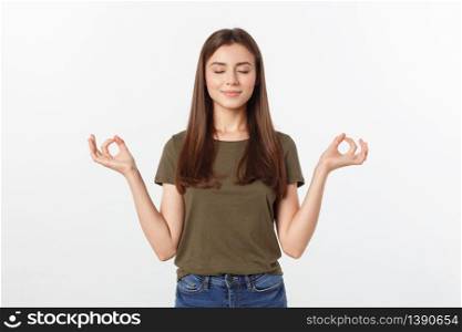 Beautiful young woman in yoga position and meditating isolated over gray background.. Beautiful young woman in yoga position and meditating isolated over gray background