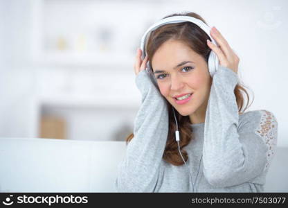 beautiful young woman is listening to music with pleasure