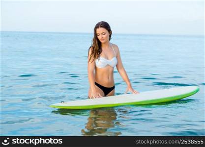Beautiful young woman learning to surf