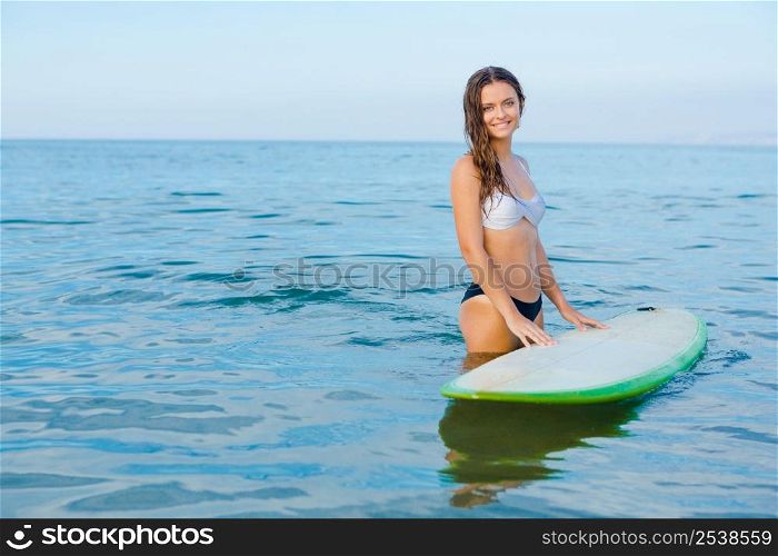 Beautiful young woman learning to surf