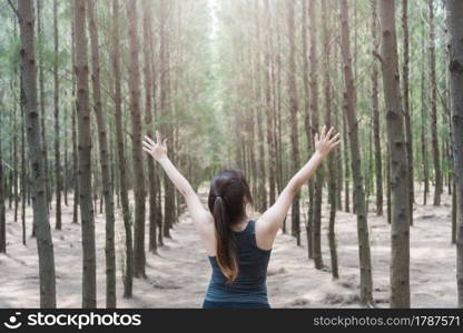 Beautiful young woman lifestyle enjoying fresh air happy relaxing in green forest park