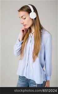 Beautiful young woman listen music with headphones. woman listen music