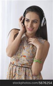 Beautiful young woman listening on headphones