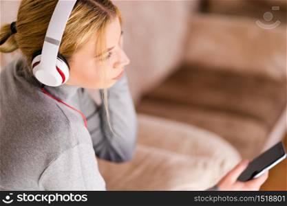 Beautiful young woman listening to the music headphones enjoy at home on holiday relax